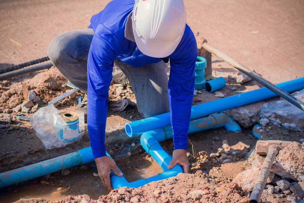 Plumber working on a busted pipe line