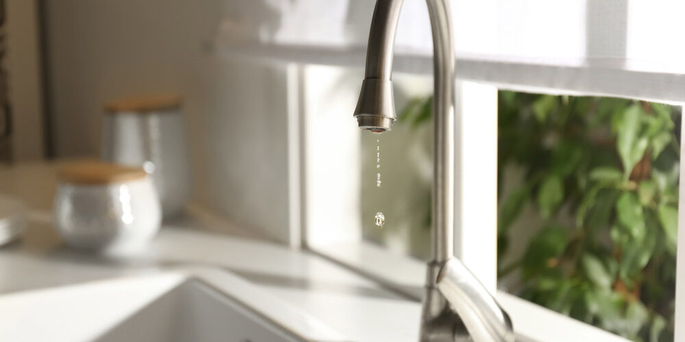 Droplets of water trickling down a tap Droplets of water trickling down a tap