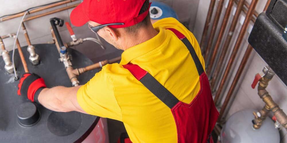 Plumber Repairing Tank Water Heater in Boiler Room Chapin, SC